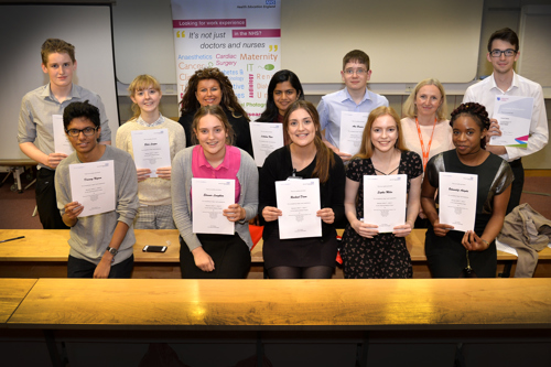 A group of aspiring medics participates smiling and holding certificates