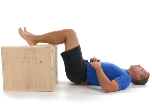 Person lying on their back with legs up on a sofa or bed