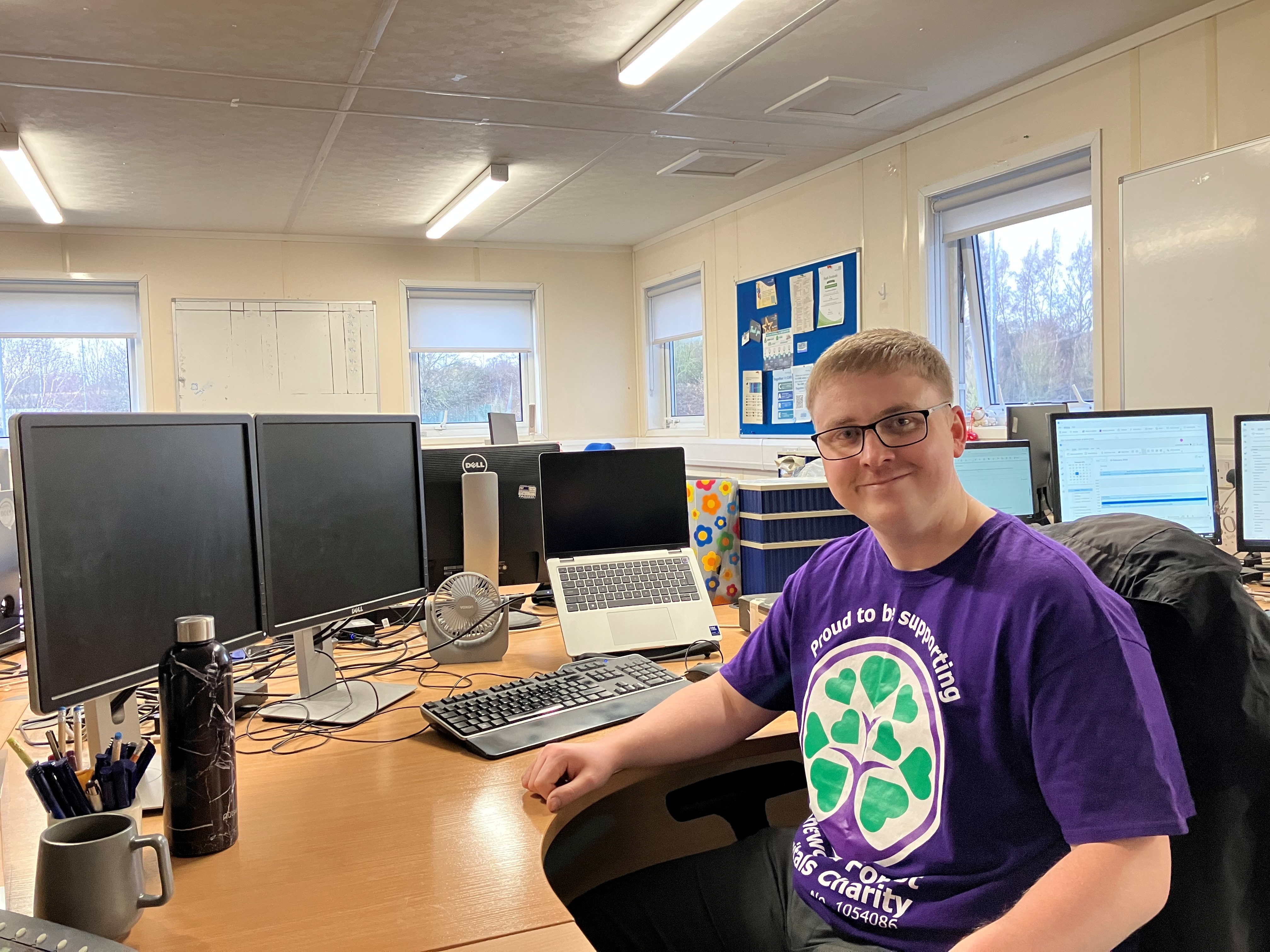A photo of Nathan Sharpe sitting at his desk