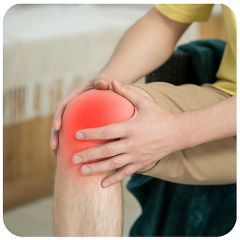 An image of a man's knee which is highlighted red to show it is painful. The man's hands are holding the knee.