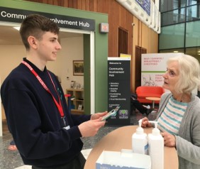 A photo of volunteer Bailey with visitor