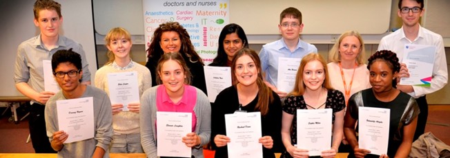 Work Experience students and staff smiling and holding certificates of completion