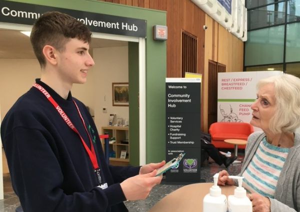 A volunteer helping a member of the public