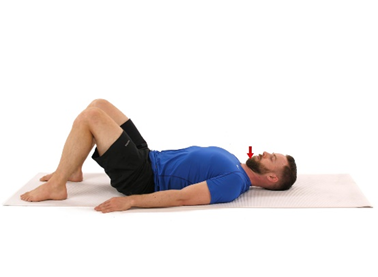 A photo of a man lying down and doing a chin tuck